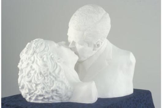 Two busts are posed to look as if they are kissing.
