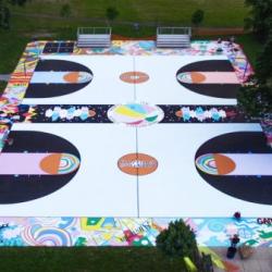 Sky view of a basketball court that has been painted with various designs and colors.