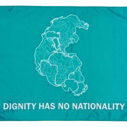 On a blue flag is the outlines of a number of bodies of water along with the text, dignity has no nationality.