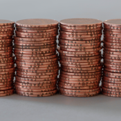 Four large stacks of pennies stand side by side.
