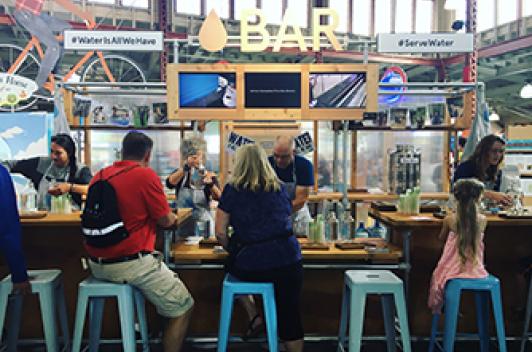 Group of people sitting at a bar. The bar is called Water Bar