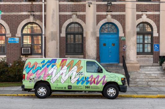 a decorated van parked on the curb