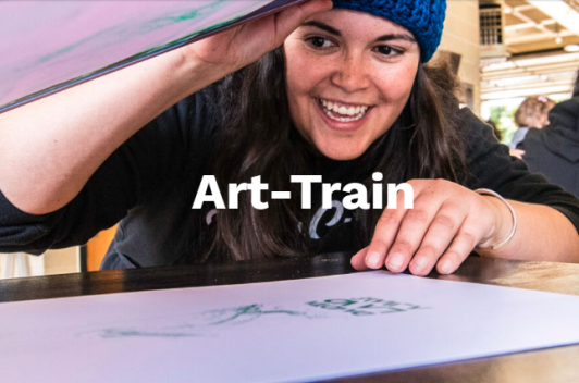 Art Train logo with a woman smiling