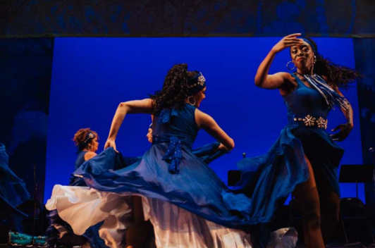 Women in blue dress dancing 