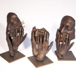 Three bronze sculptures of hands