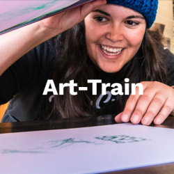 Art Train logo with a woman smiling
