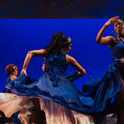 Women in blue dress dancing 