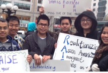 Group of smiling people holding signs about the civil rights of undocumented Asians in American
