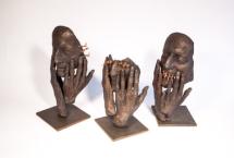 Three bronze sculptures of hands
